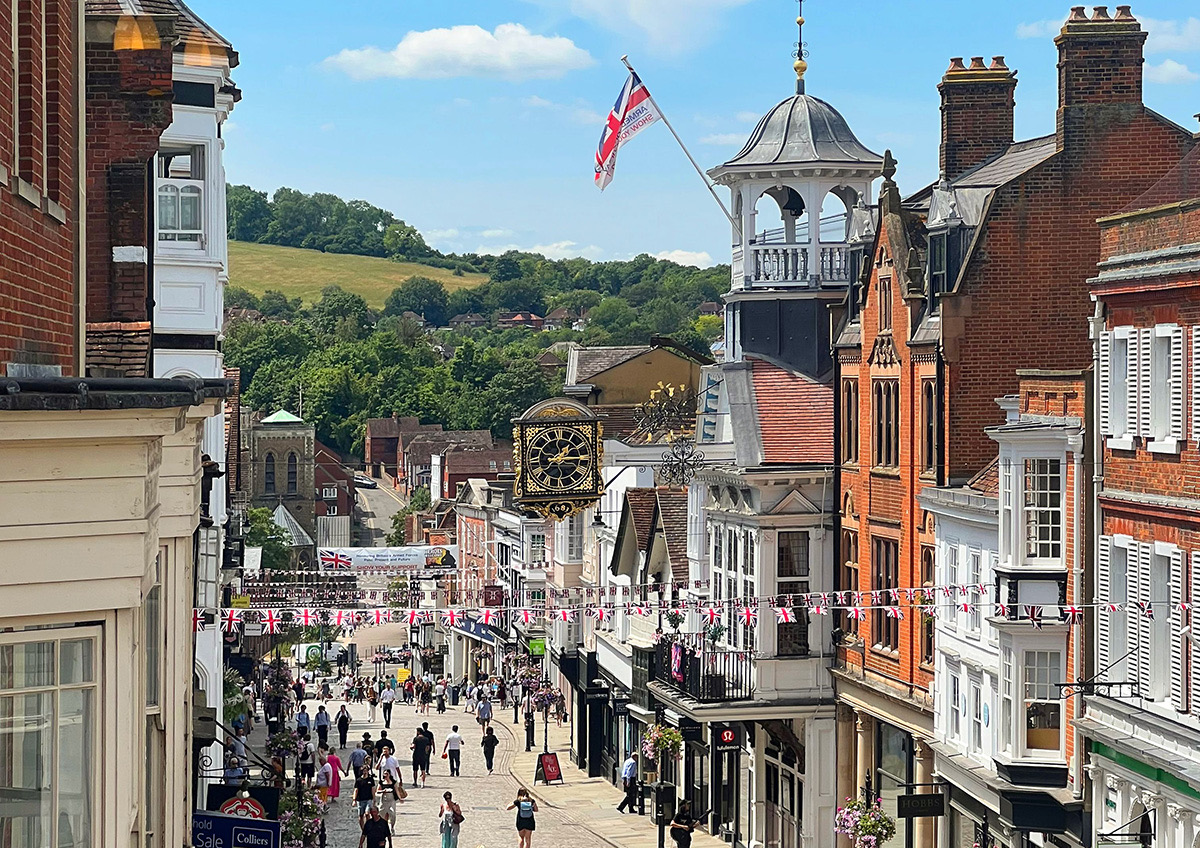Guildford High Street with the Guildhall clock and the Surrey Hills beyond